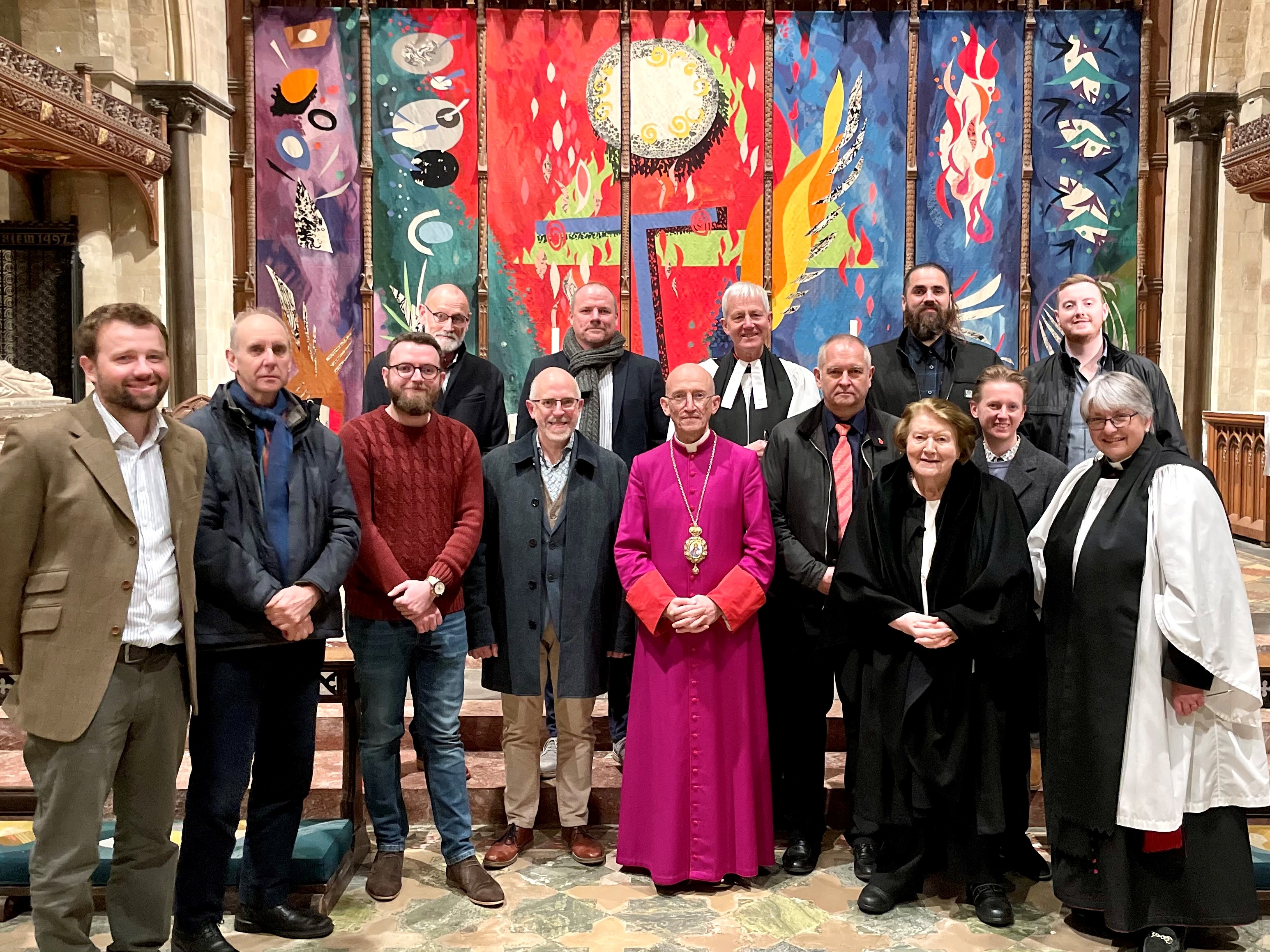 A group of people who worked on the Cathedral roofing and lighting pose for a photo in front of the Cathedral's High Altar- also including the Bishop of Chichester the Right Reverend Dr Martin Warner, Canon Treasurer the Revd Vanessa Baron and Dame Patricia Routledge Patron of the roof restoration.