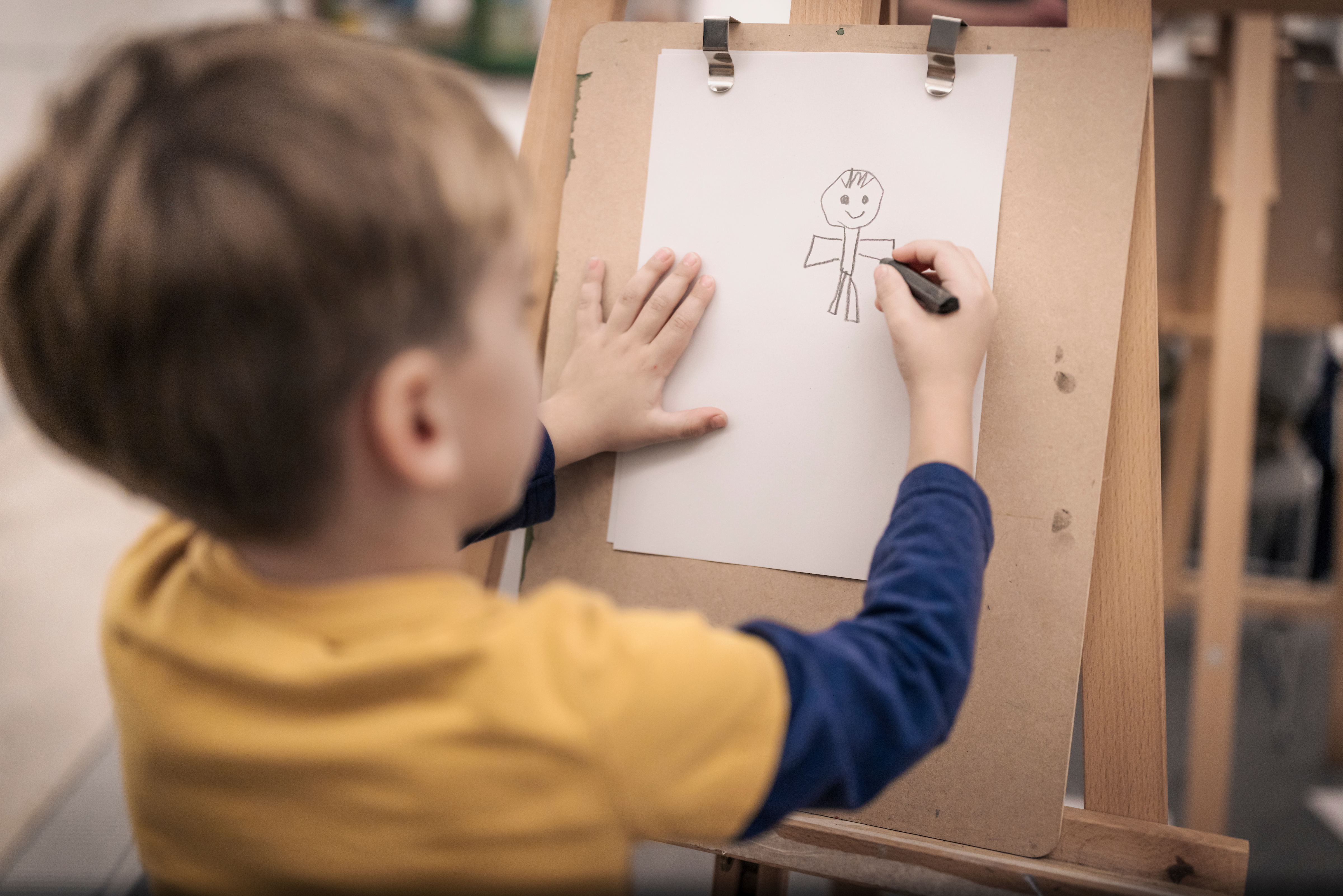 A child draws a picture of a person