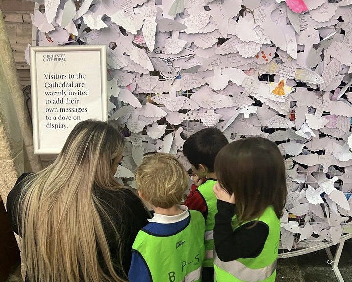 Young children read peace dove messages