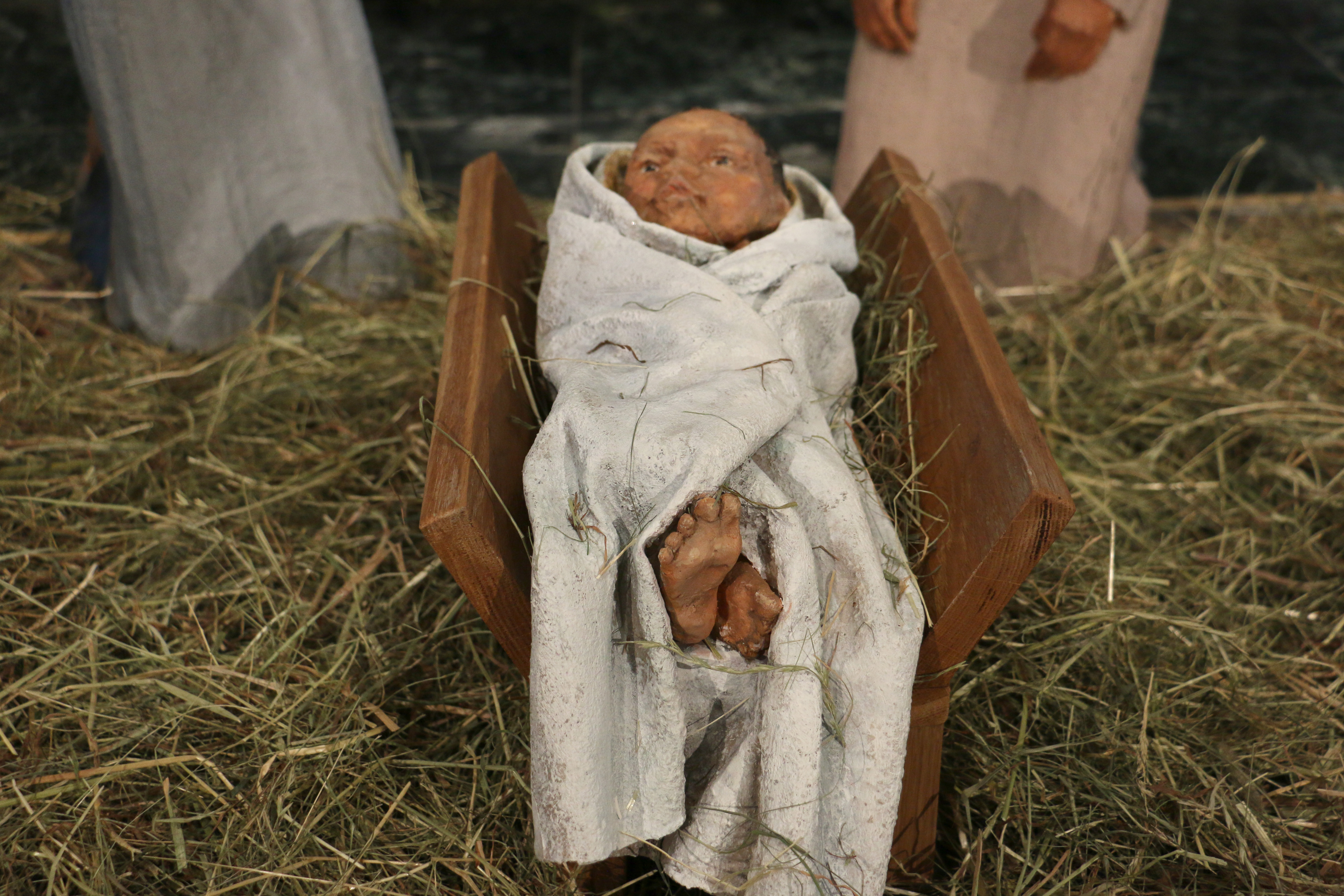 Sculpture of Christ Child showing the feet, swaddled in white cloth