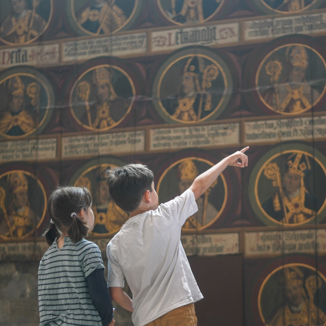 children point at a tudor art work