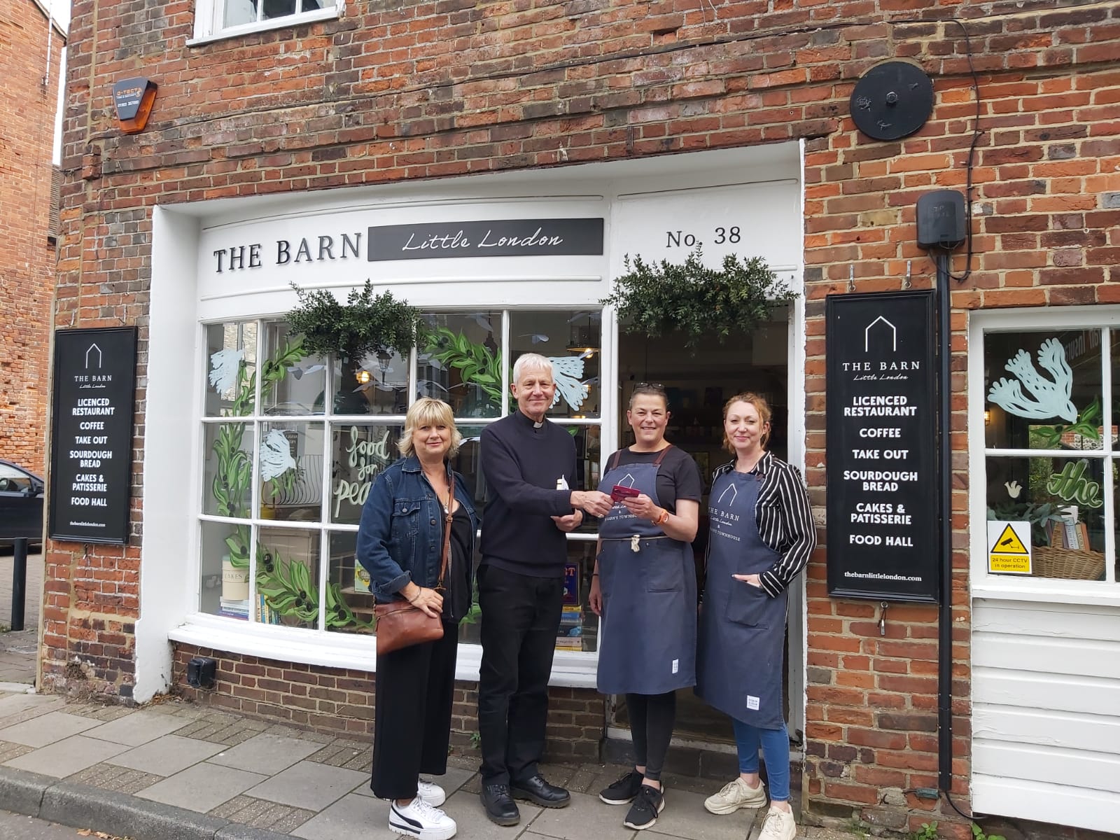 The Interm Dean, Simon Holland, and CEO of Chichester BID Helen Marshall, stand alongside the competition winners