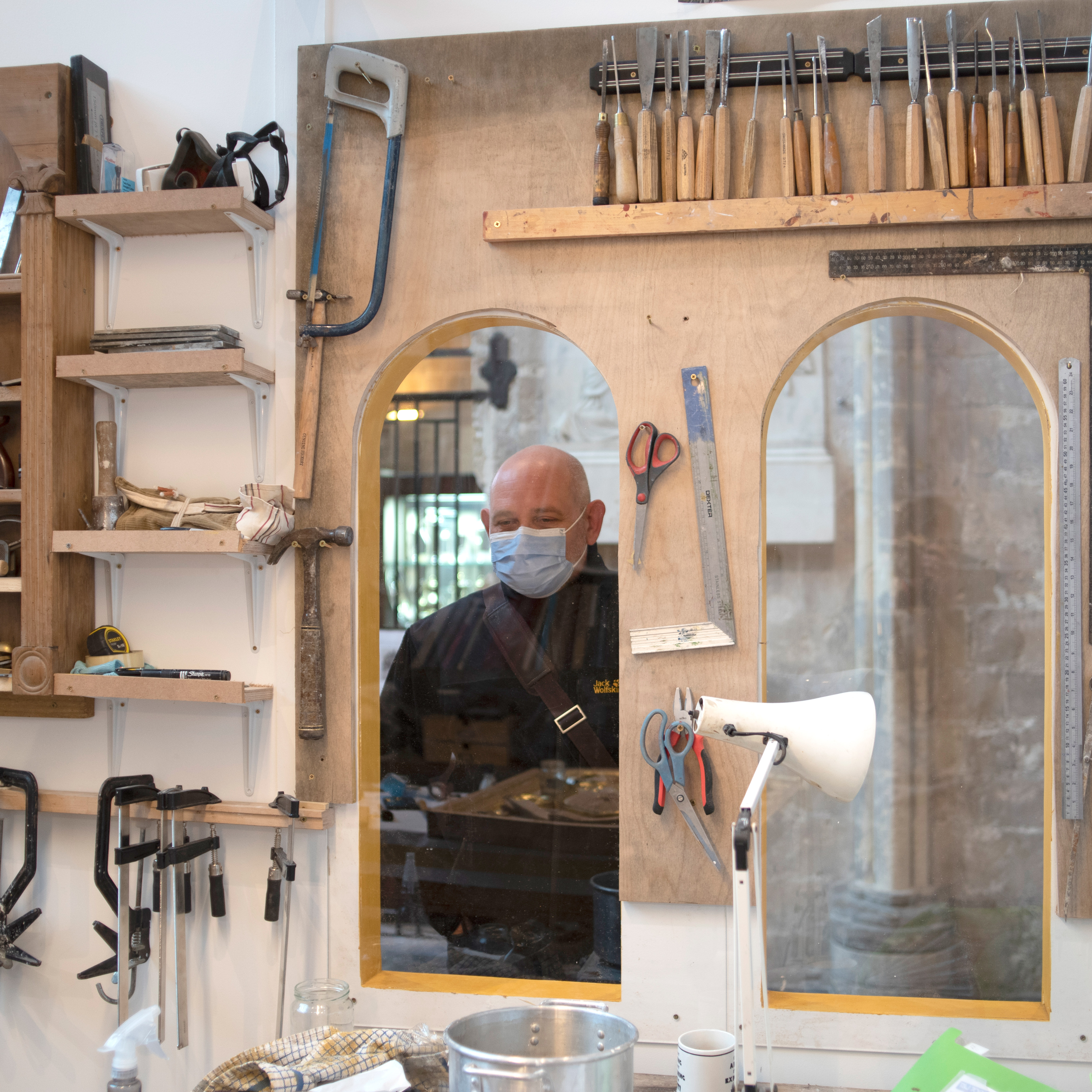 A visitor looks through a studio window