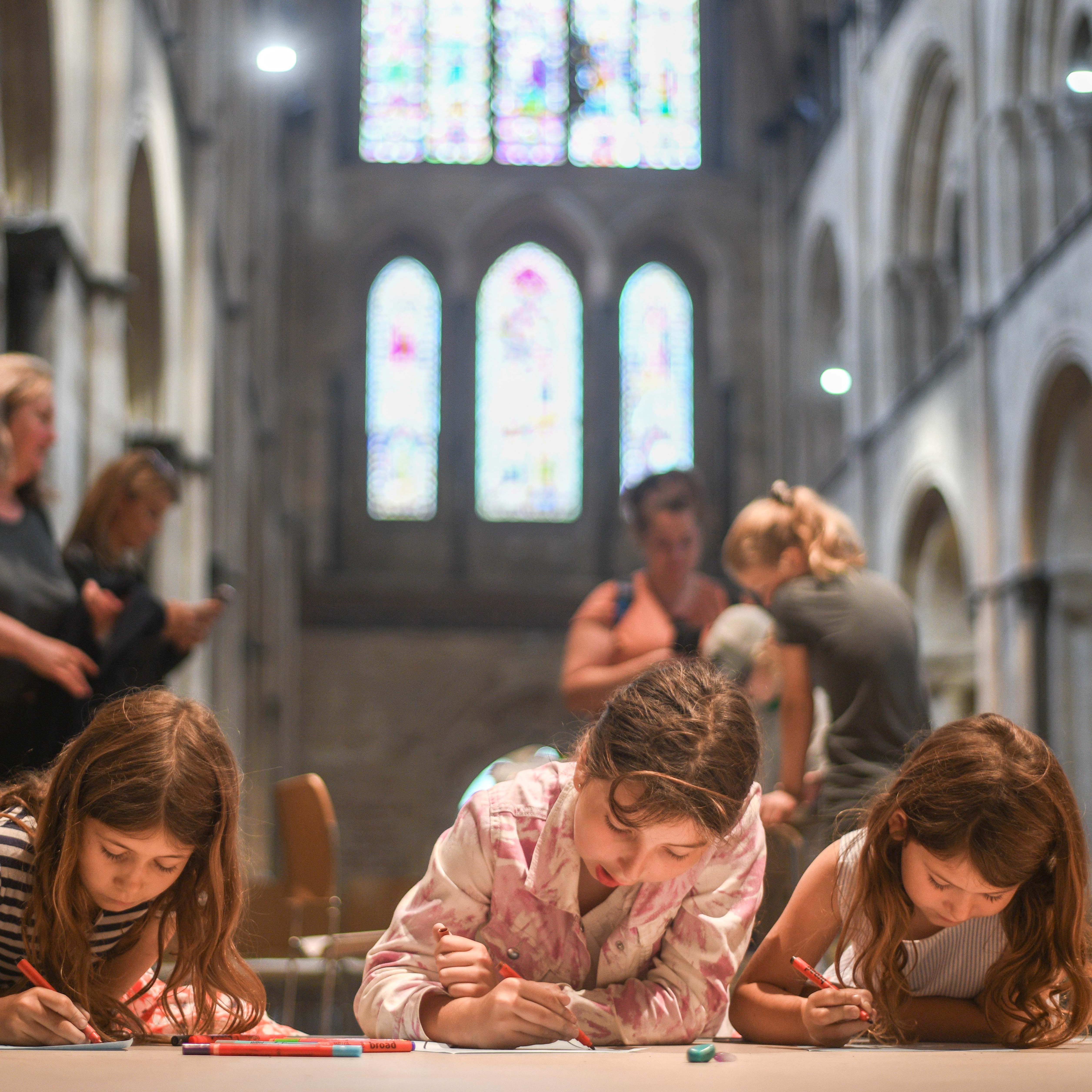 Children drawing in cathedral