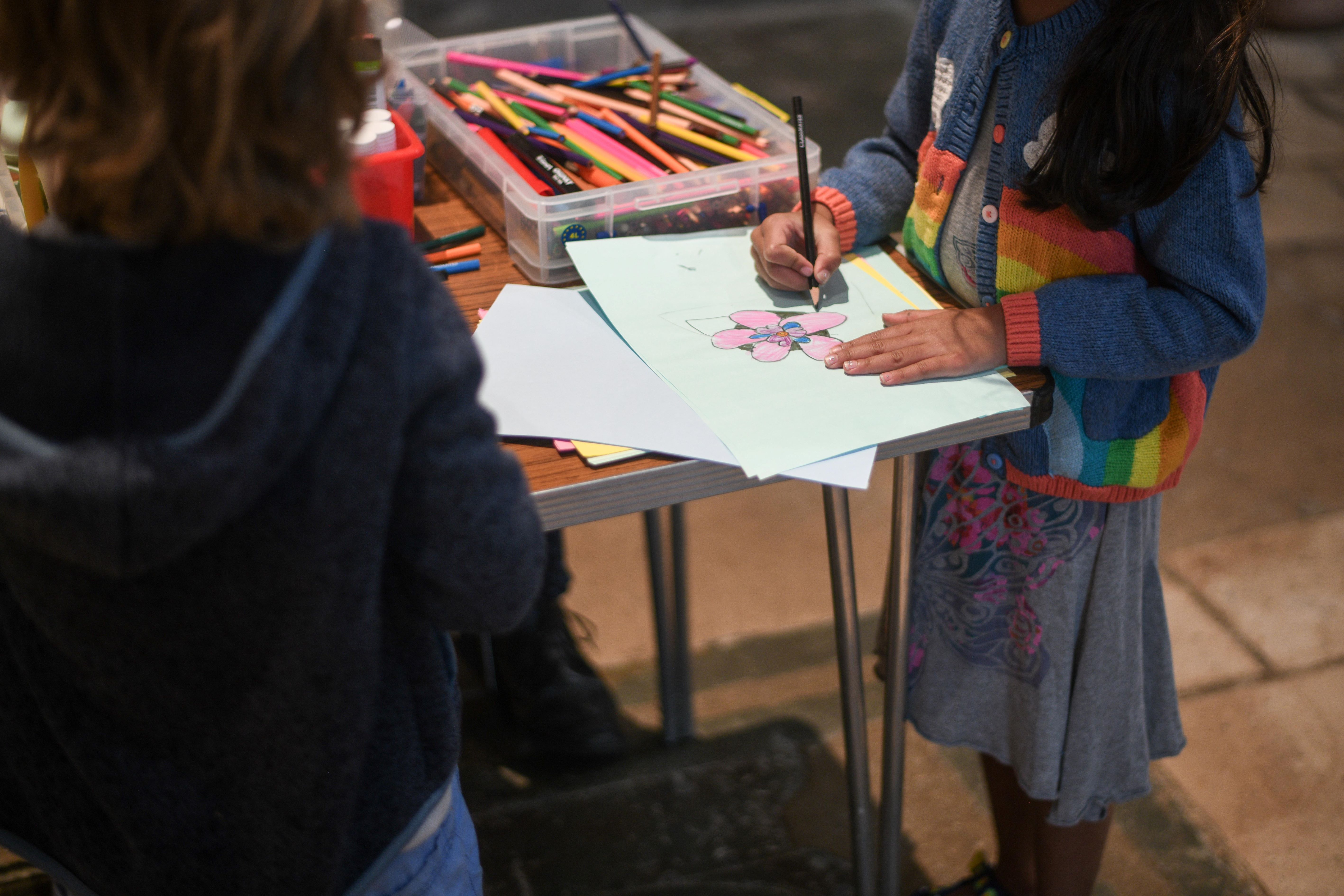 A child draws a flower