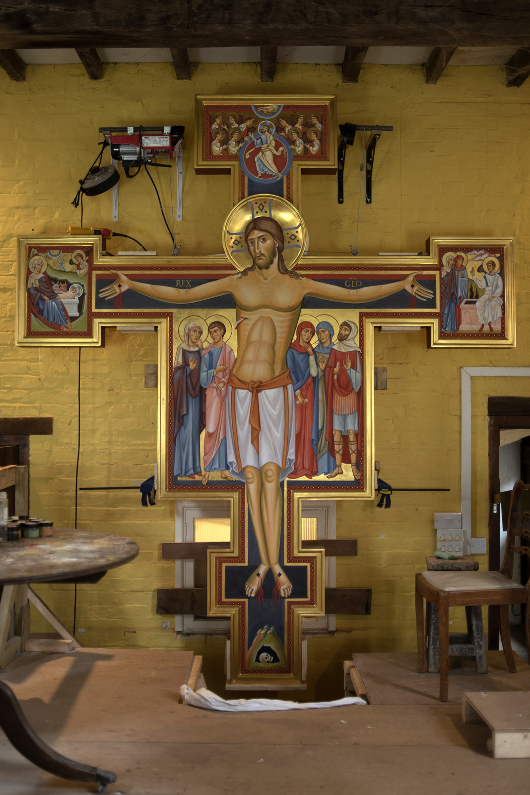 10 x 8 foot crucifix of Christ, traditional ‘egg tempera’ technique built up in thin layers over a timber panel. The background is in burnished gold
