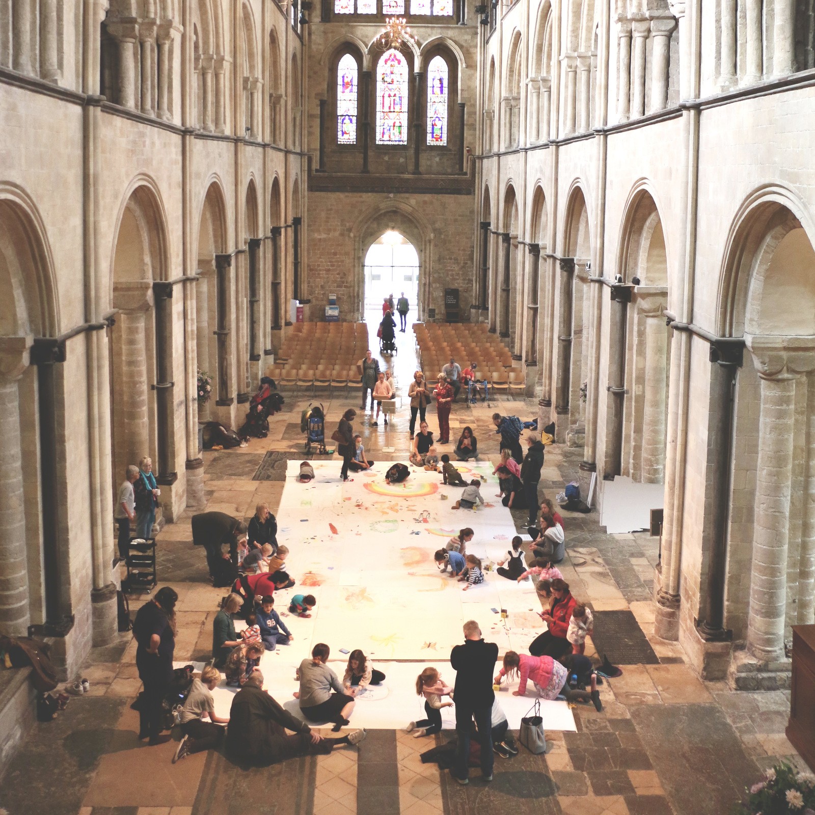 Cathedral Nave floor covered in large paper sheets with children drawing