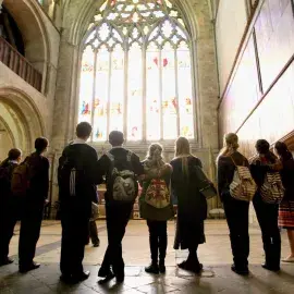 School group looking at stained glass window