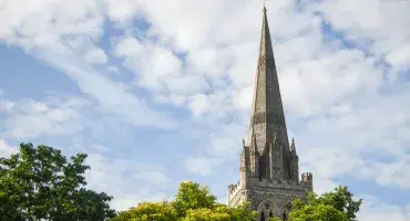 The Cathedral spire behind a line of trees