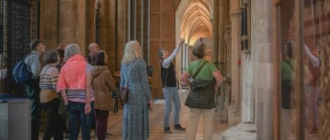 A guide gives a tour of the Cathedral aisles