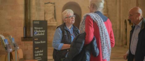 A Volunteer greets visitors to the Cathedral