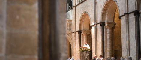 Priest in a pulpit addresses the congregation