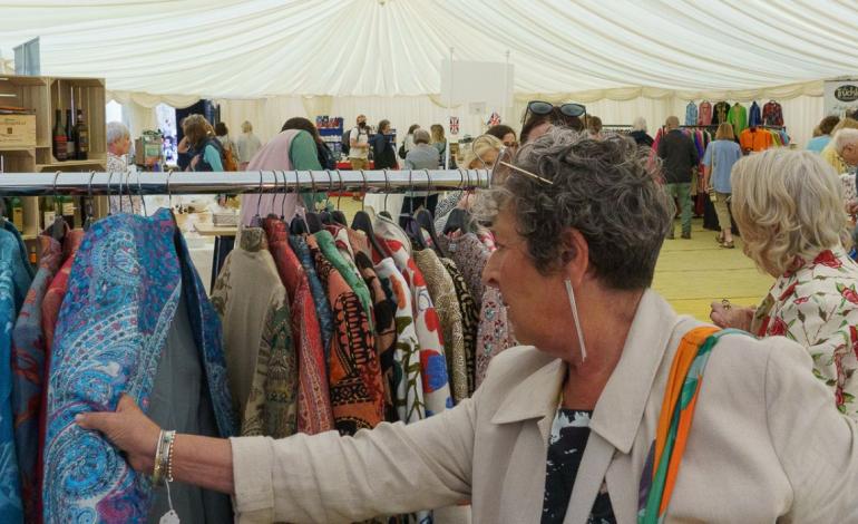a woman browsing at a clothes stand