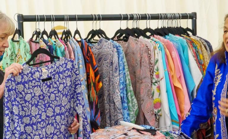 a woman browsing at a clothes stand