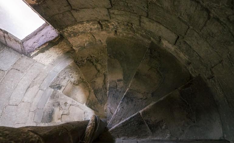 Medieval stone spiral staircase within Chichester Cathedral, winding through the historic fabric of the building.