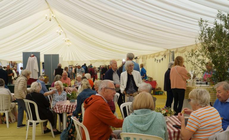 people sitting at cafe tables in marque