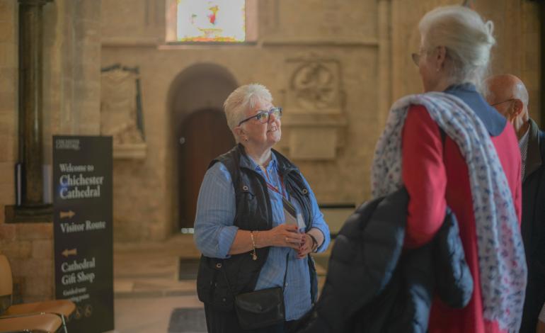 A welcomer greets visitors at the Cathedral entrance