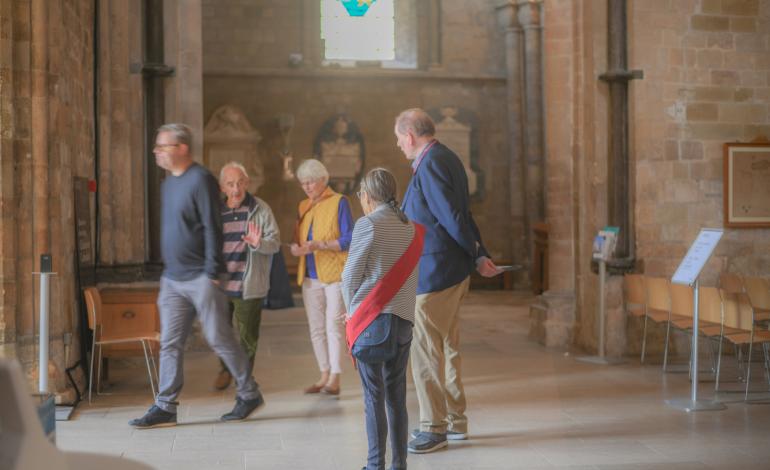 Volunteers say goodbye to visitors leaving the Cathedral
