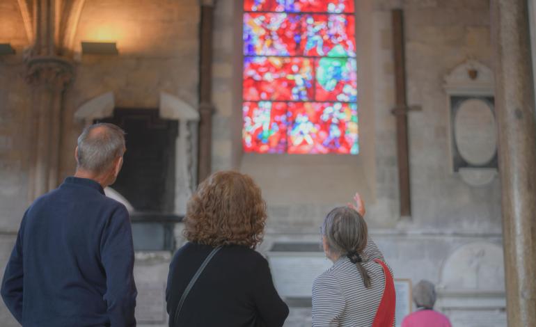 a volunteer guide showing the Chagall window