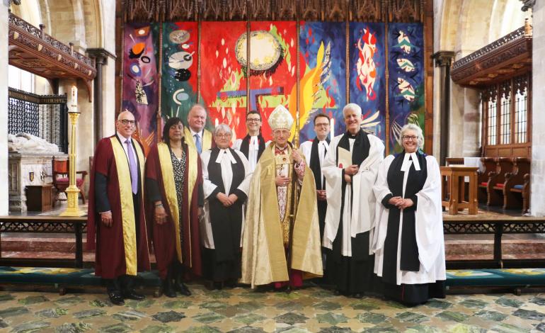 Simon Holland, Interim Dean of Chichester standing with the Bishop of Chichester and members of the Cathedral's Chapter