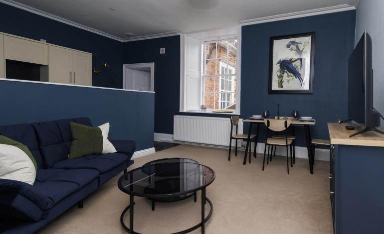 Open living with dinner table, sofa and TV