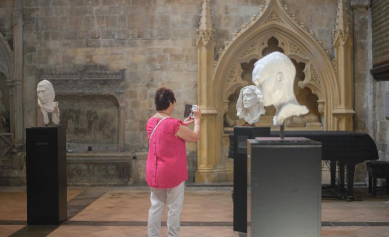 a visitor looks at a sculpture