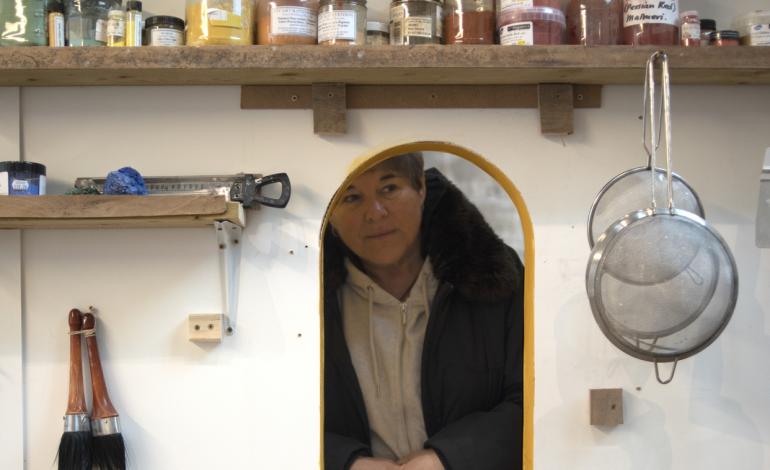 A visitor looks through the studio window