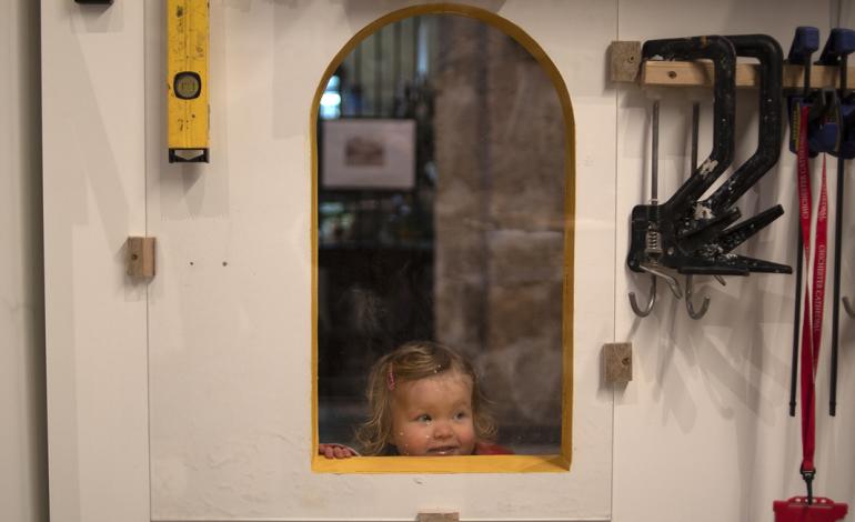 A visitor looks through the studio window