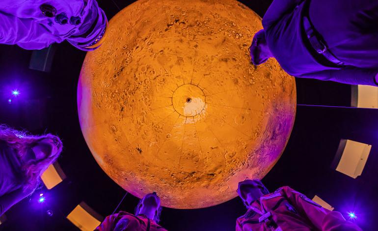 People stand under Mars