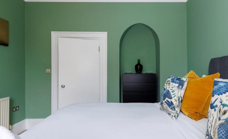 Bedroom door view with view of small alcove and drawer storage.