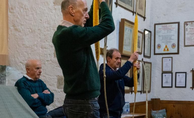 Two men prepare to pull on a long rope which rings the Cathedral bells