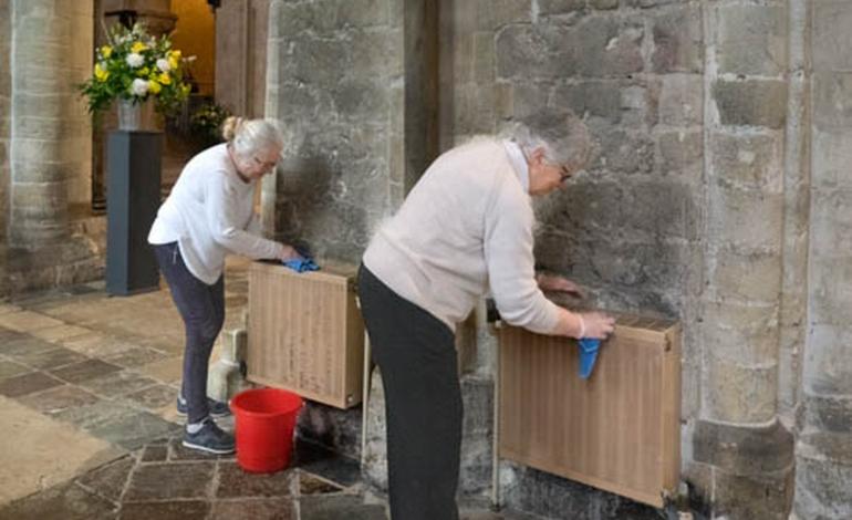 Two holy dusters scrub the Cathedral radiators clean