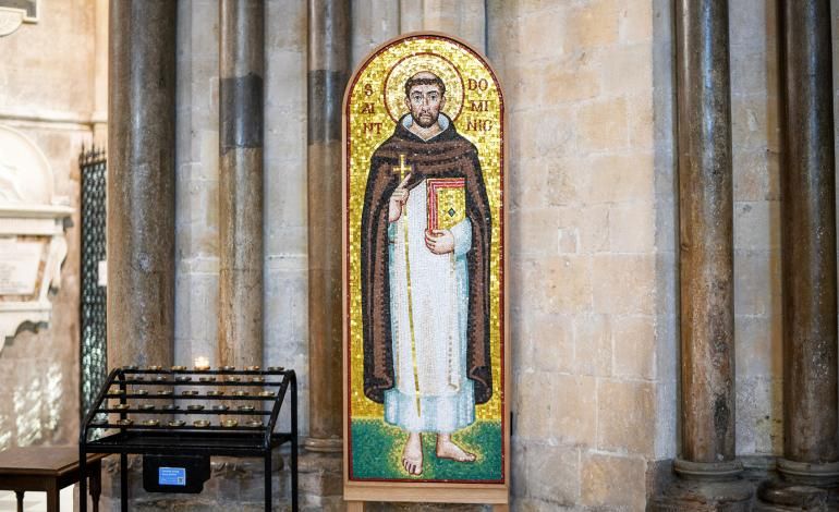 The Mosaic of Saint Dominic sits on a wooden stand