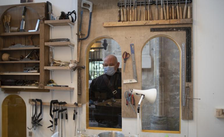 A visitor looks through the studio window