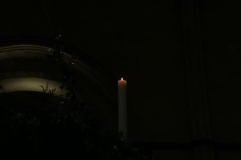 Lit candle on Advent wreath