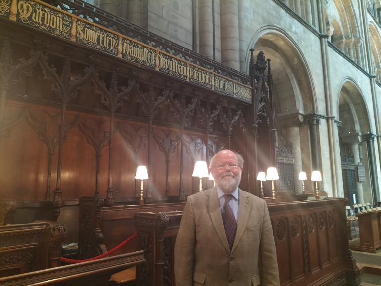 David Riley (wearing a suit) standing in the Quire stalls