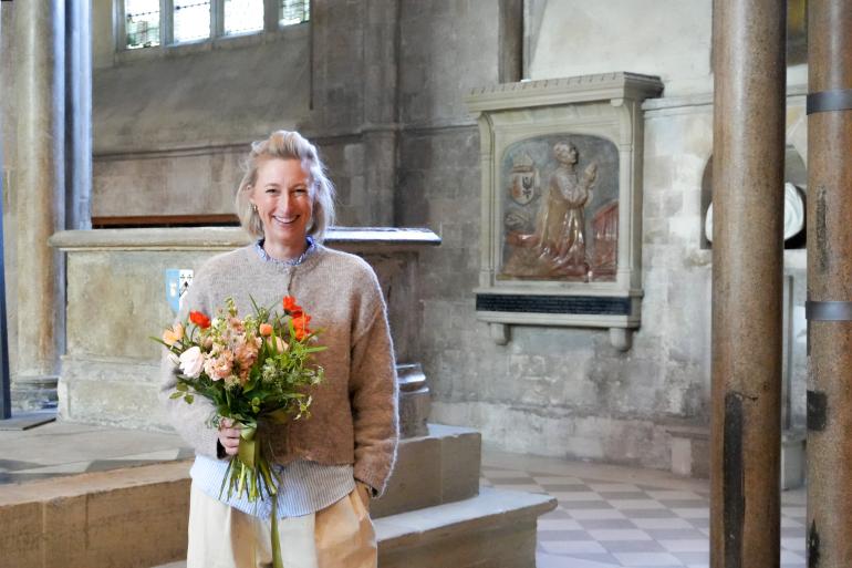 Caroline Daines Holding flowers infront of the St Richard's Shrine