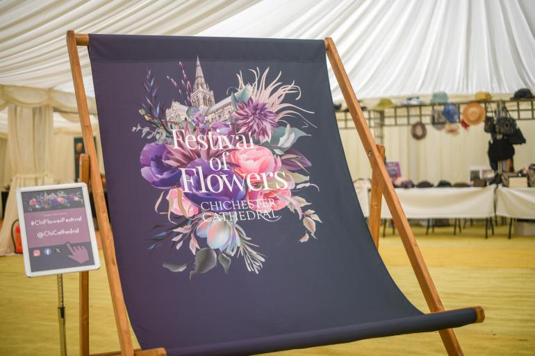 A large Deck Chair inside tent with Festival of flowers design