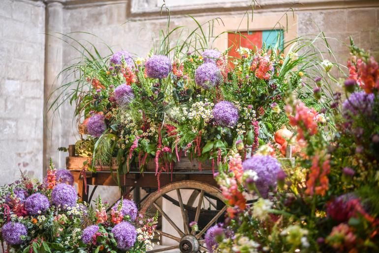 Flowers arranged in a wooden cart