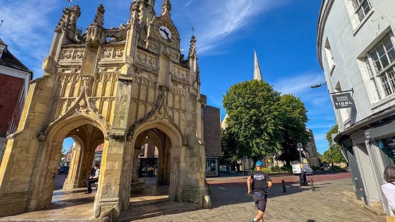 A runner passes Chichester's Market Cross