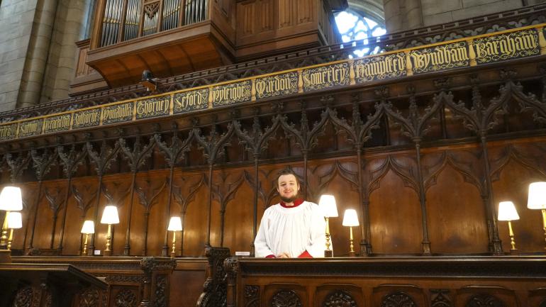 Organ Scholar, Christopher Reid, in the Quire stalls