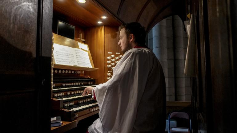 Organ Scholar, Christopher Reid, playing the organ