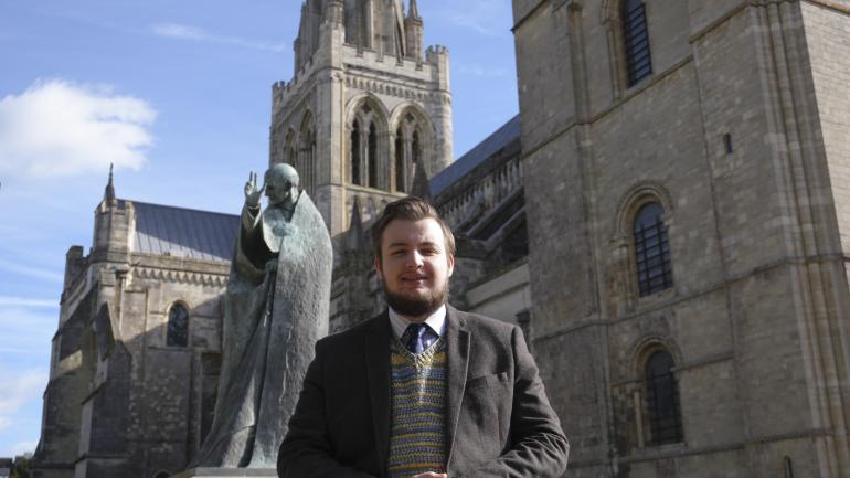 Organ Scholar, Christopher Reid, infront of Chichester Cathedral